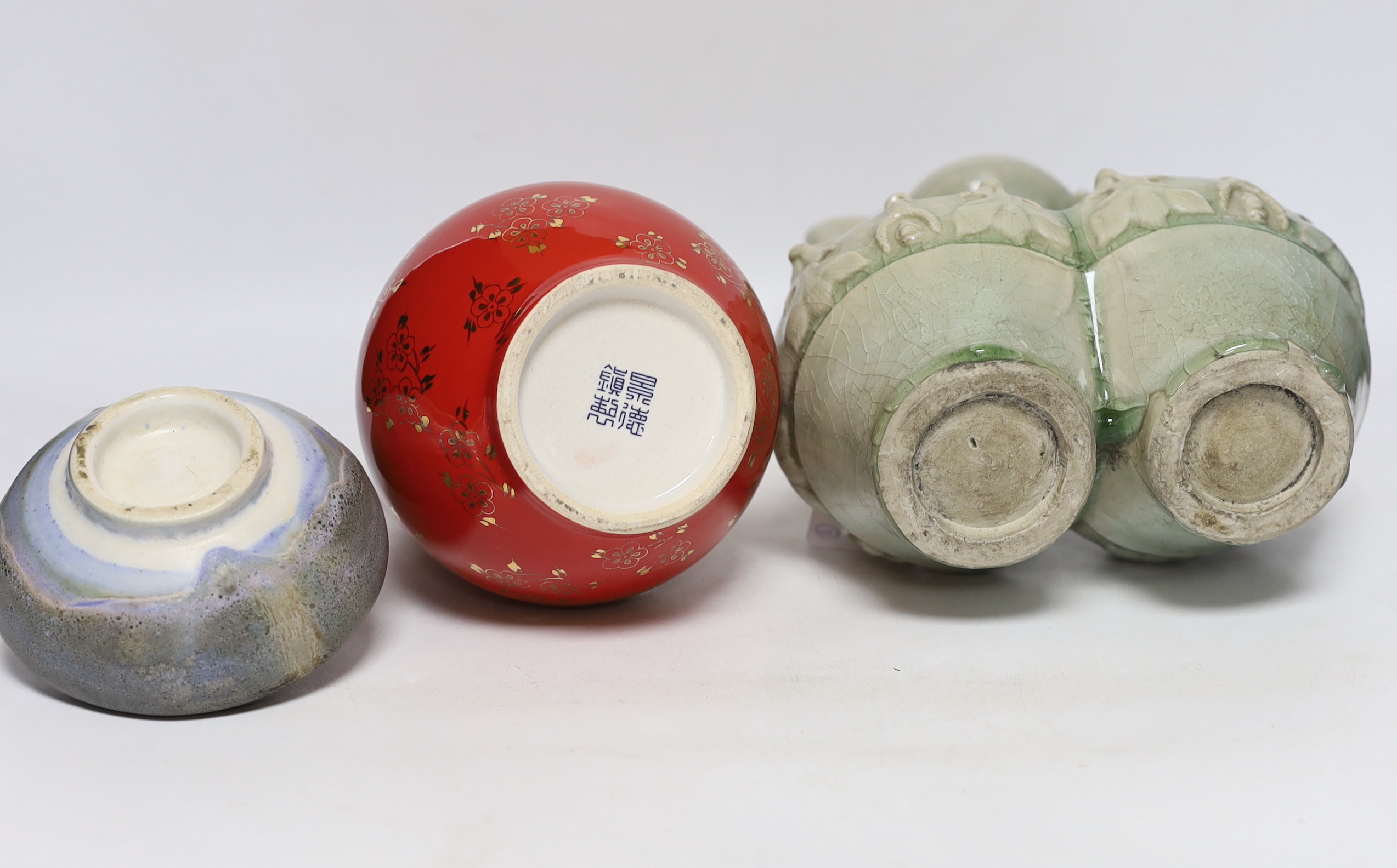 A Chinese red ground vase, Chinese celadon conjoined dragon handled vase and a studio pottery vase, 25cm